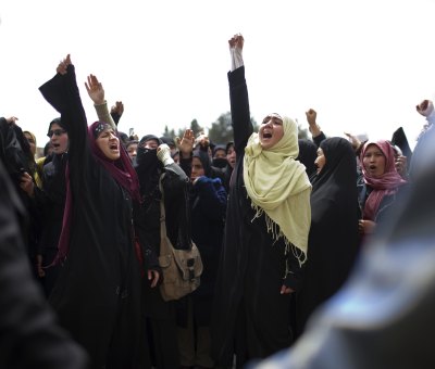 Women holding their fist in the air to protest a new family law in Afghanistan