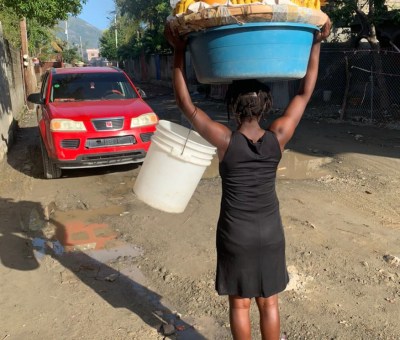 Woman carries fruit in Haiti